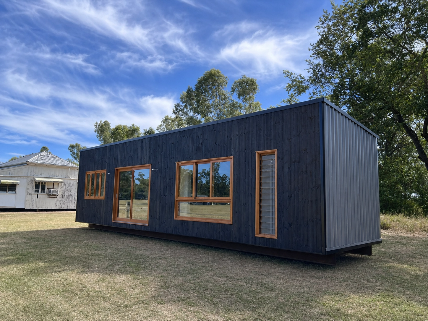 Forge 12 exterior — Shou Sugi Ban charred-timber cladding under a Queensland sky
