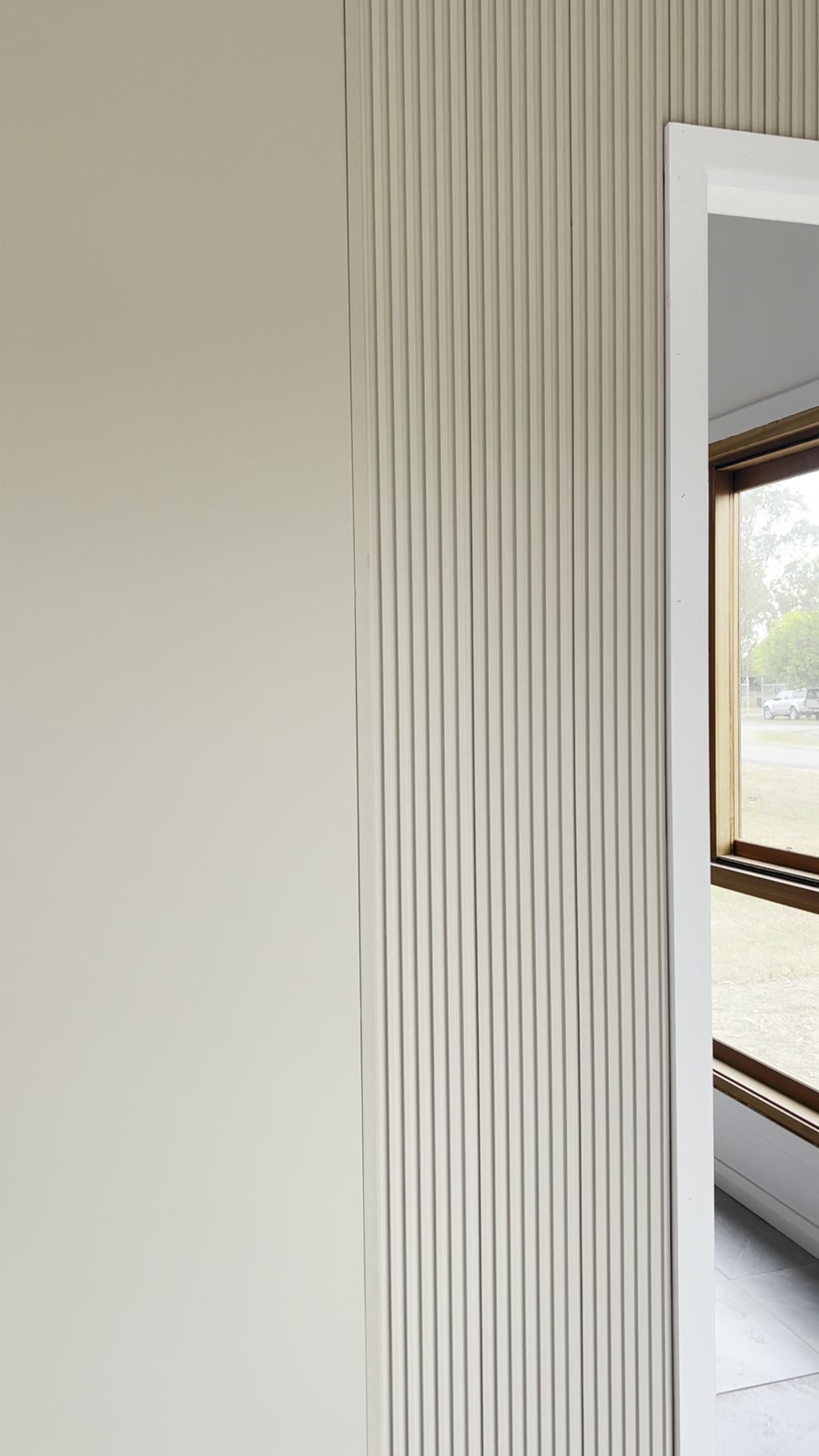 Forge 12 interior — oak-battened fluted feature wall and 3m ceiling height